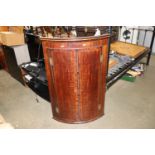 A mahogany hanging corner cupboard