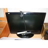 A Toshiba flat screen television with remote contr