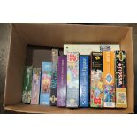 A box of various jigsaw puzzles