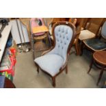 A blue upholstered button back bedroom chair