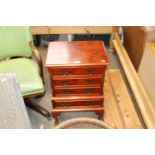 A reproduction chest fitted four drawers raised on