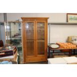 A modern pine display cabinet fitted single drawer