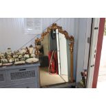 A gilt framed wall mirror