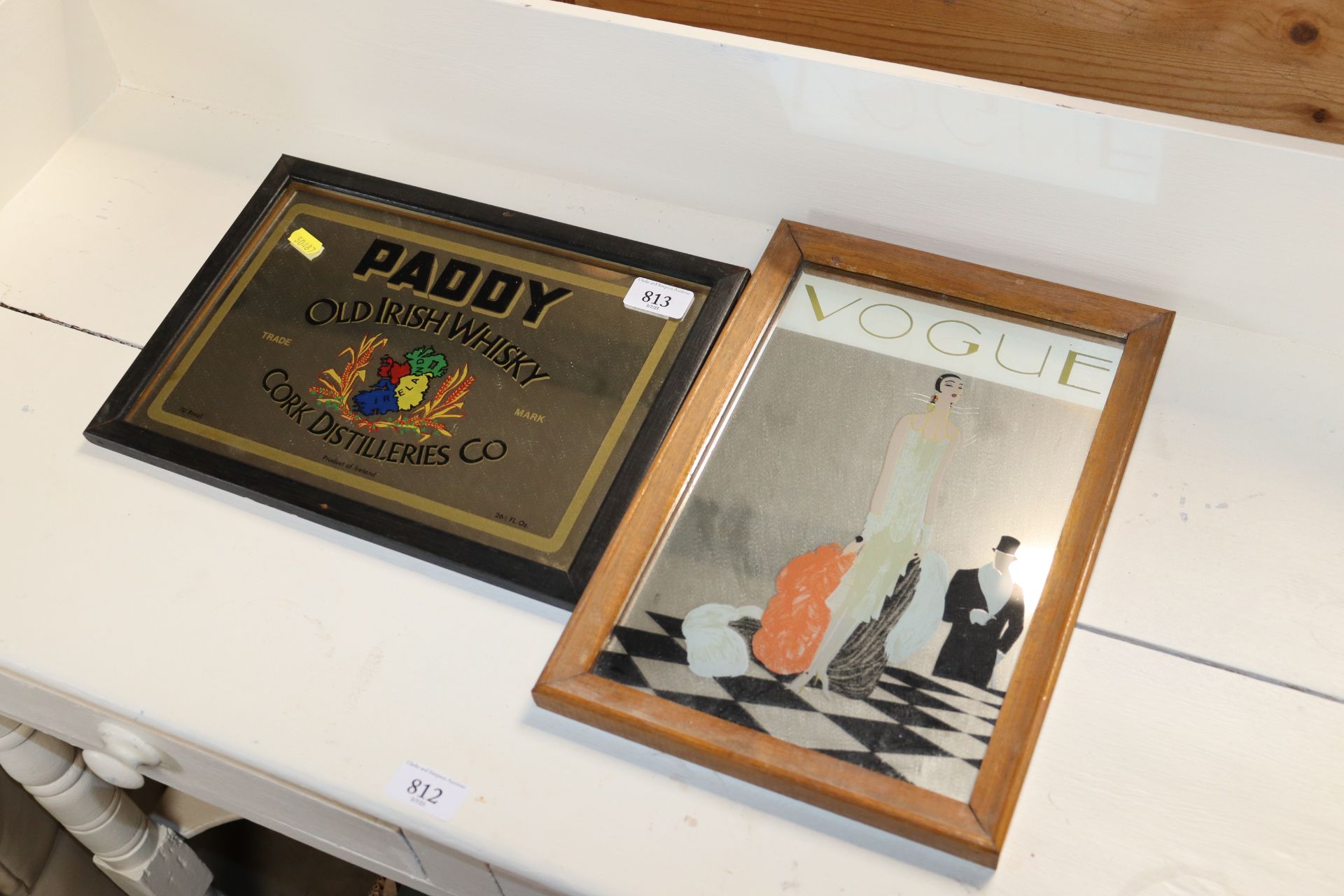 A Vogue advertising mirror together with a Paddy's