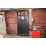 A black painted partially glazed front door