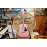 A Swift Pink acoustic guitar