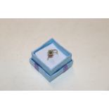 A 14ct gold ring set with turquoise and cubic zirc