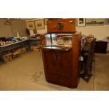 An Art Deco cocktail cabinet with lift-up top