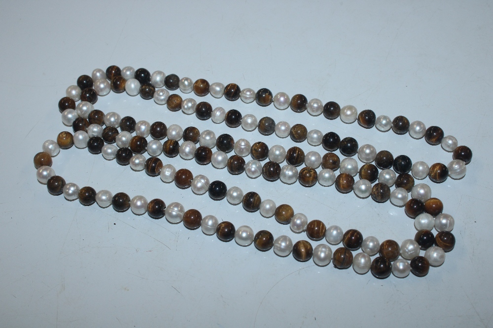 A string of tigers eye and pearl type beads