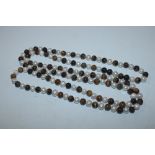 A string of tigers eye and pearl type beads