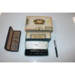 A cigar box and contents of Parker propelling penc