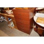 A teak effect six drawer chest