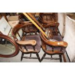 A set of four tub shaped spindle back elbow chairs