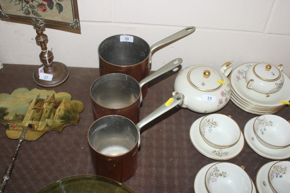 Three antique copper saucepans by Elkington & Co.