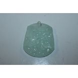 An oriental jade type carved pendant