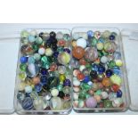 Two tubs of various marbles