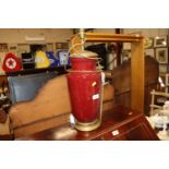 A red glazed pottery and brass mounted table lamp