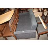 A retro style put you up settee in charcoal grey