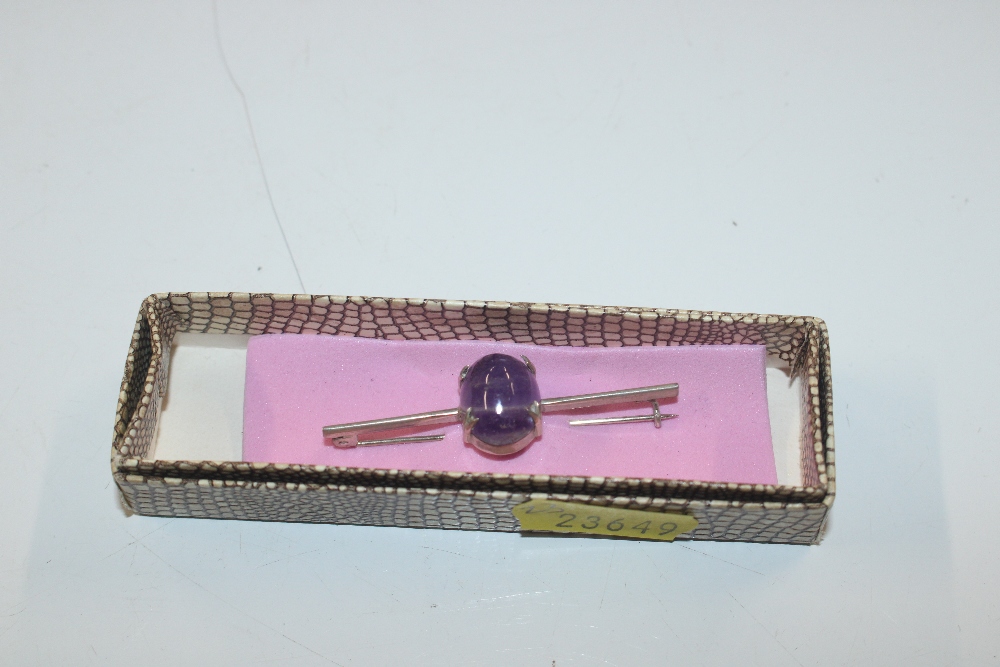 A silver banded amethyst brooch