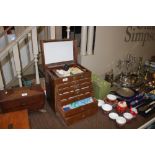 A small wooden multi drawer medical cabinet and co