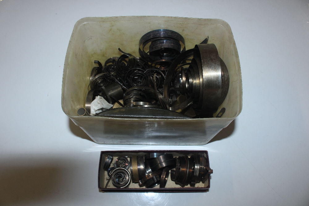 A box containing various clock main springs etc.