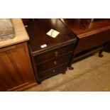 A mid-20th Century walnut three drawer bedside che