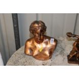 A metal and coppered bust depicting Venus