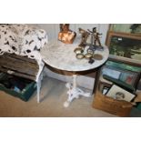 A vintage marble topped conservatory table on cast
