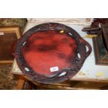 An Oriental lacquered circular tea tray with drago