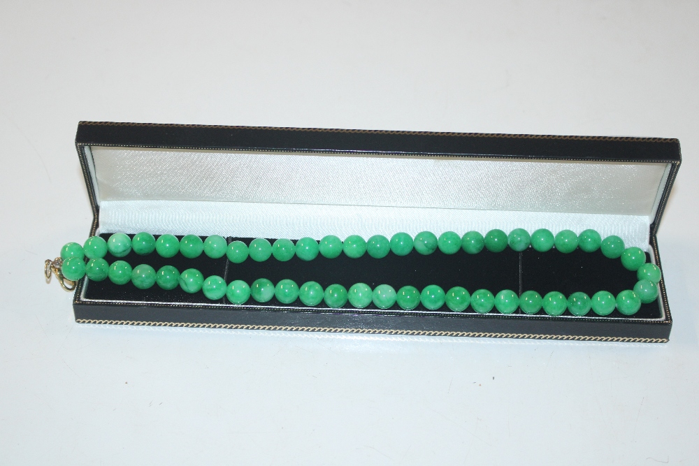 A boxed jade type bead necklace