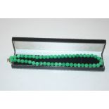 A boxed jade type bead necklace