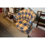 A buttoned tub chair in tartan upholstery