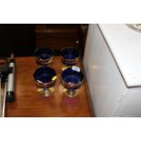 Four blue glass and gilt overlaid goblets