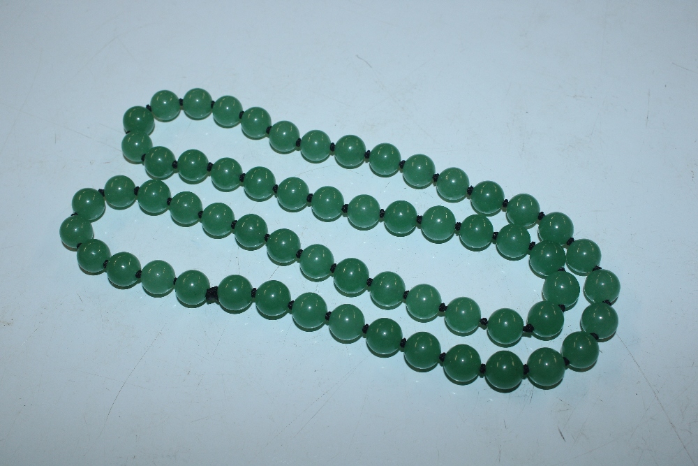 A string of green coloured jade type beads