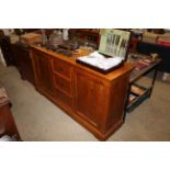 A golden oak side cabinet fitted drawers and cupbo