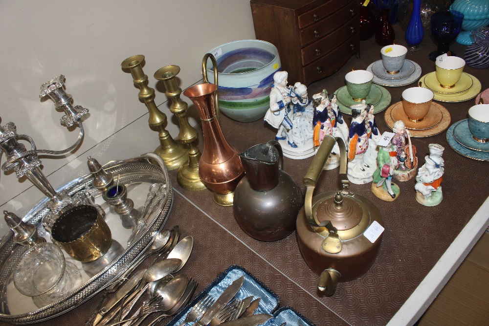 A pair of antique brass candlesticks; a copper Art