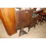 An antique oak snap top occasional table on turned