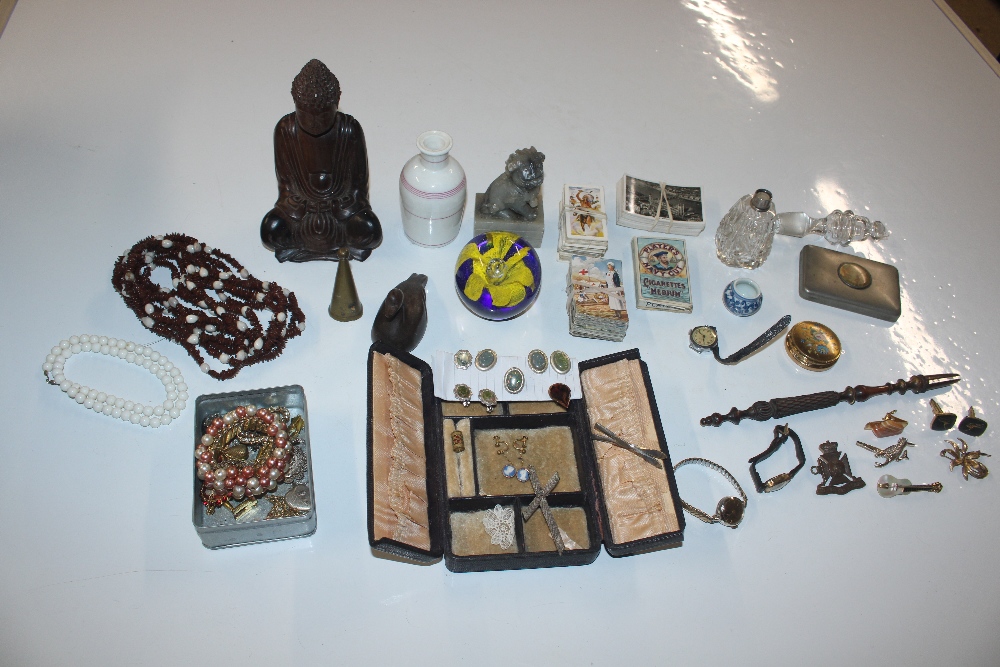 A box containing various costume jewellery, carved