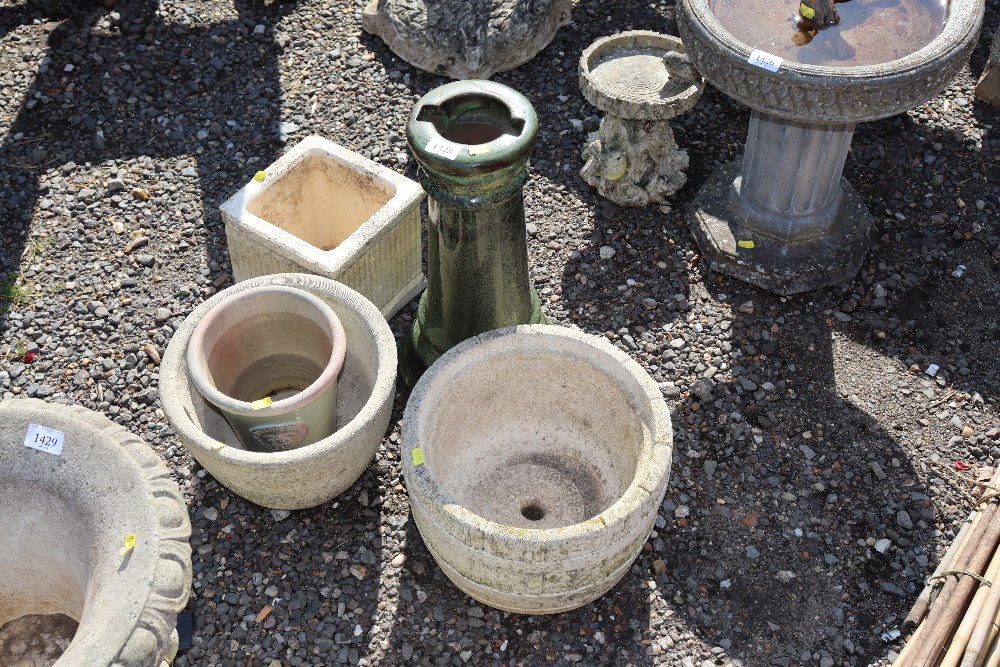 A green glazed plant stand together with various p