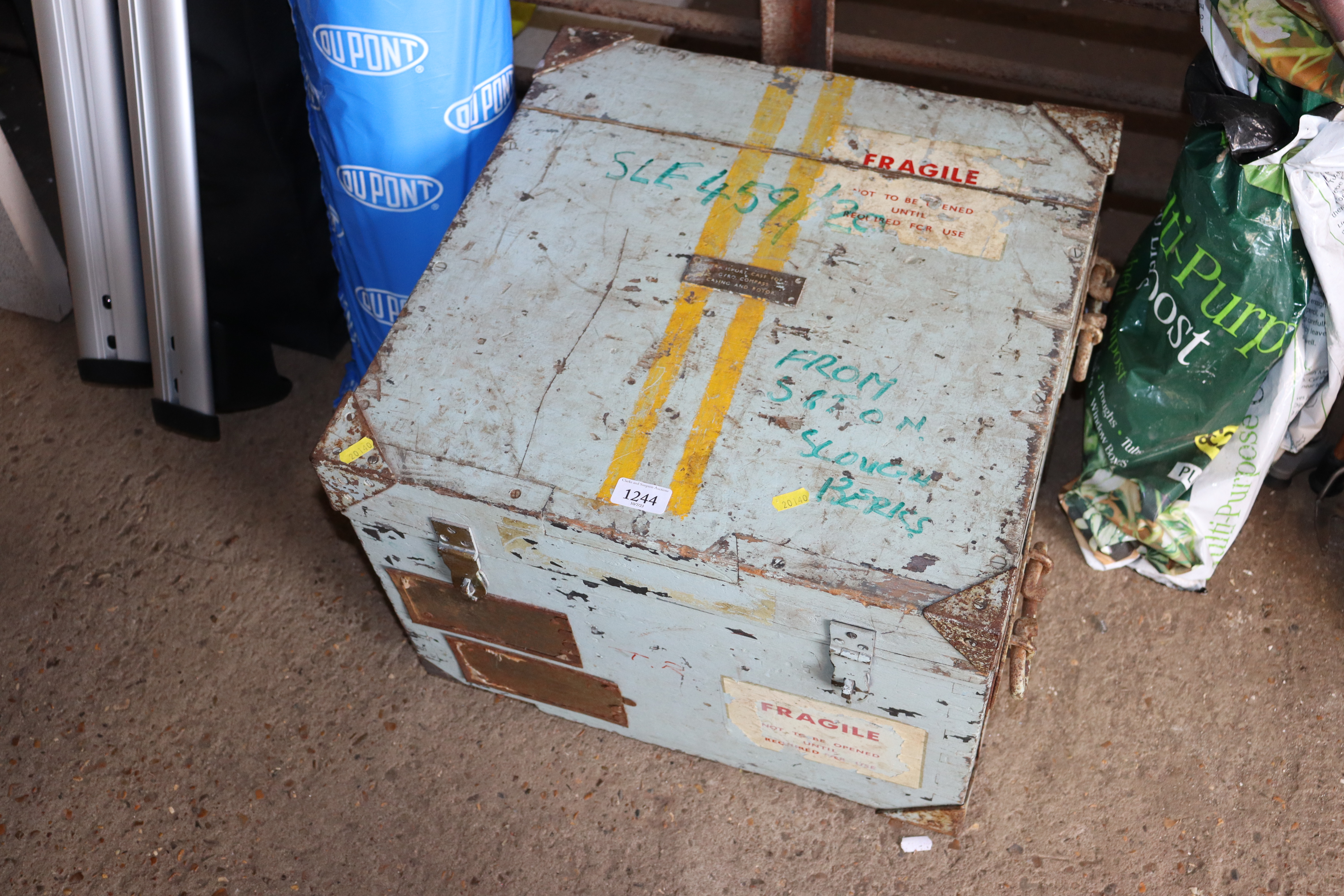 A wooden and metal bound storage trunk with plaque