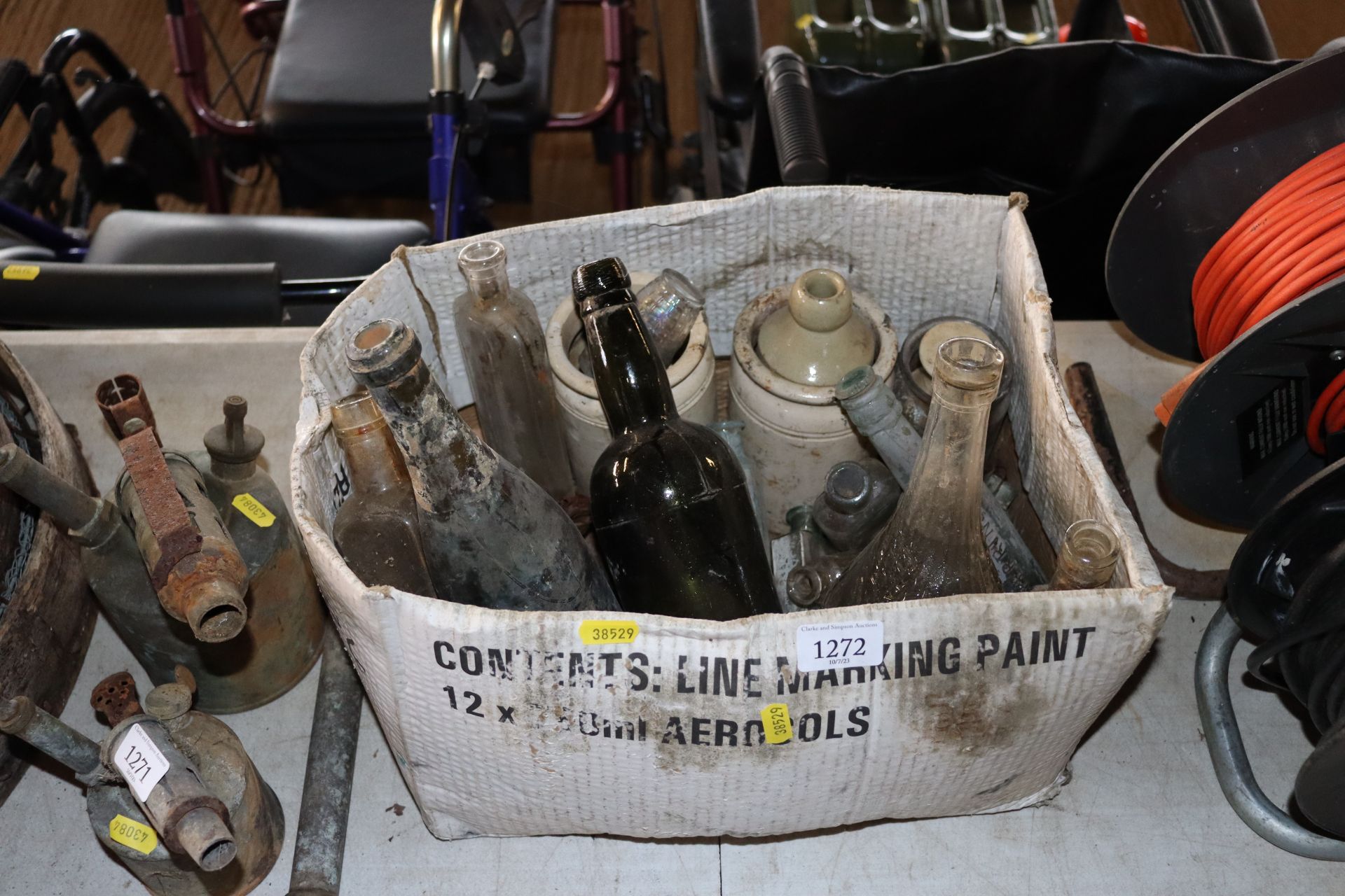 A box containing various vintage glass bottles and