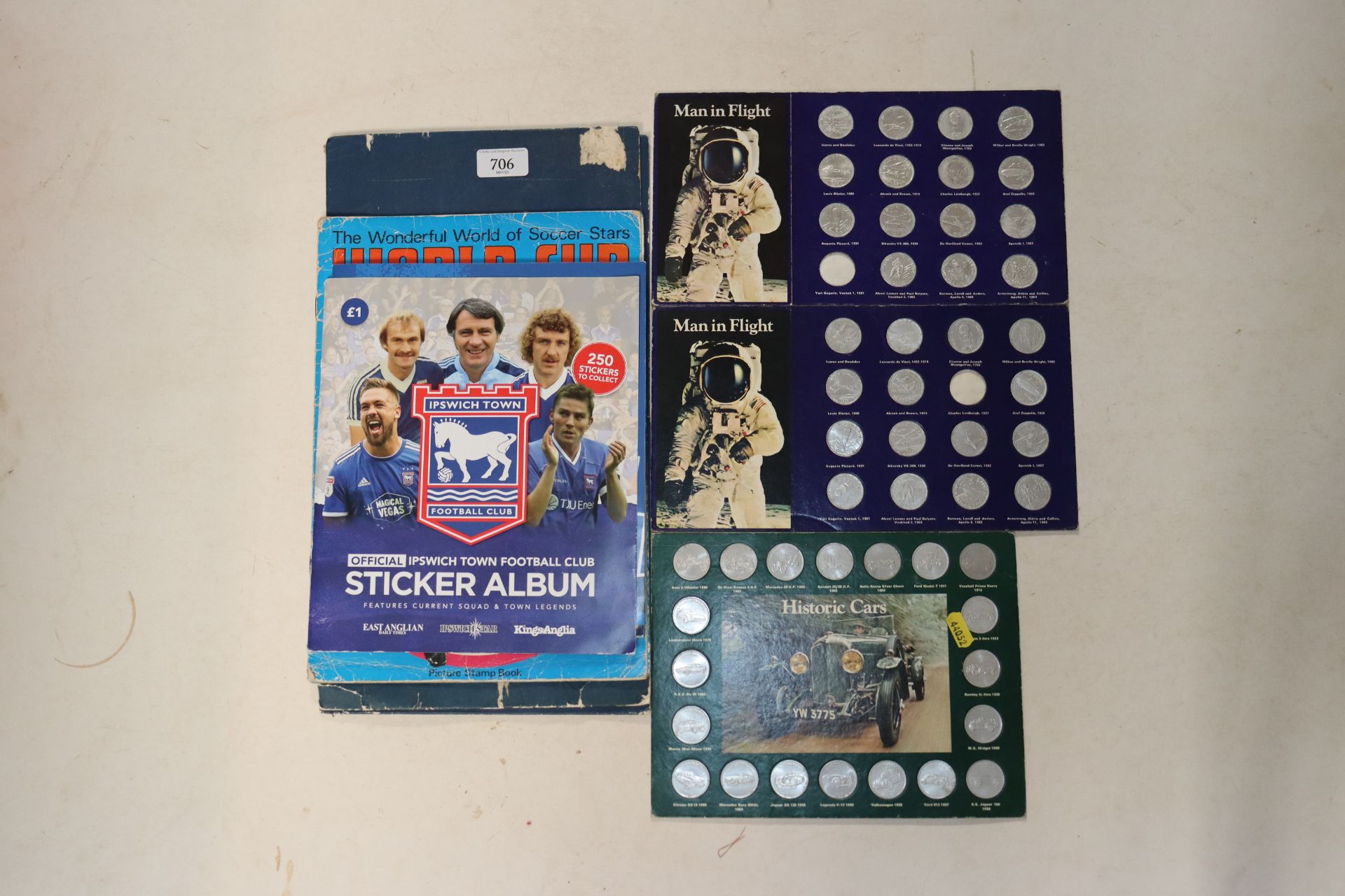 A quantity of collectors coins, Ipswich Town sticker album, World Cup 1974 soccer stars album etc