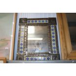 A decorative framed wall mirror