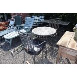 A circular tile topped garden table and pair of metal