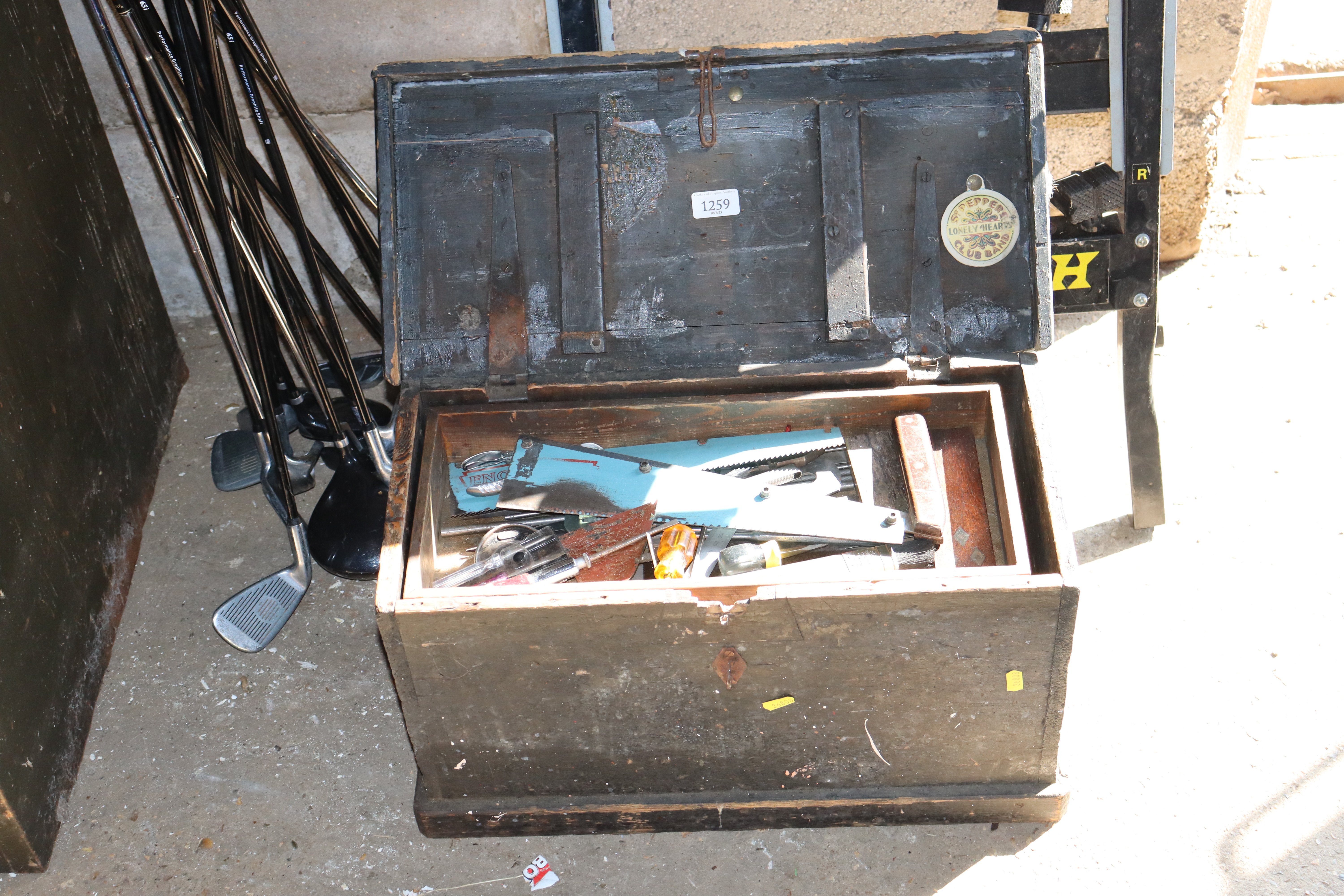 A wooden carpenters chest and quantity of tools