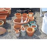 A quantity of various sized terracotta planters an