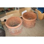 Two large terracotta planters with floral decorati