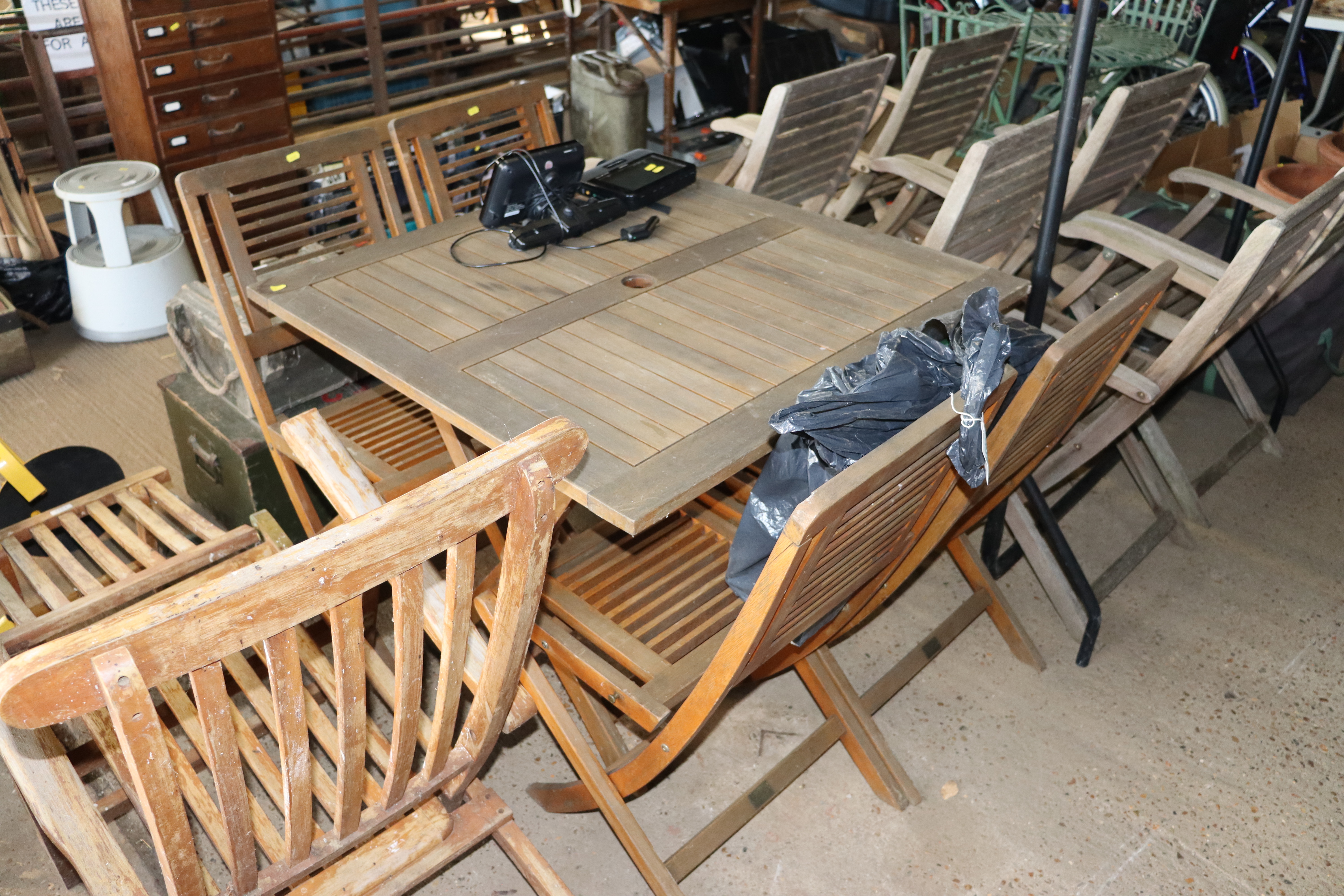 A wooden folding garden table and set of four matc