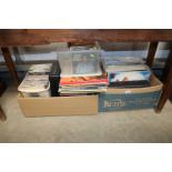 A collection of various records, including LPs 45rpm records and 45 cassette tapes