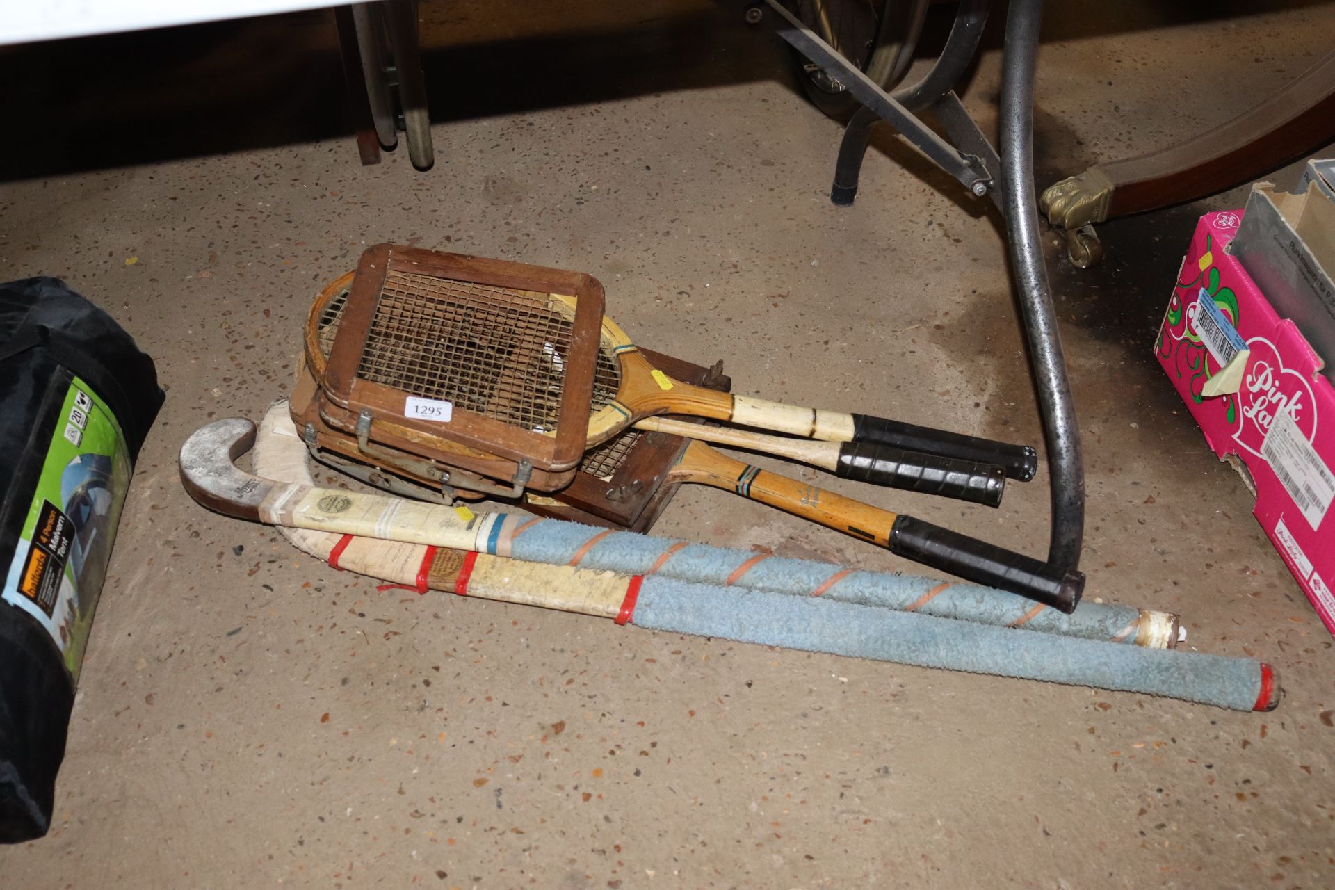 Two hockey sticks, a vintage badminton racquet and